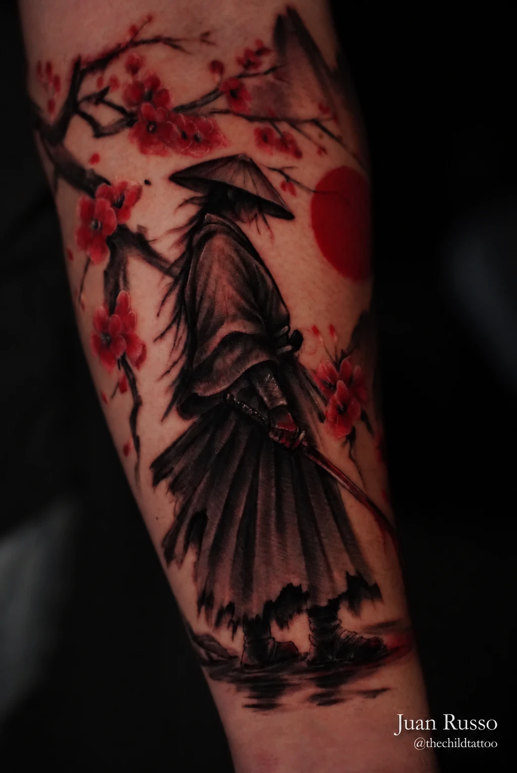 Rōnin and red blossoms tattoo by Juan Russo in Cordova, Memphis.
