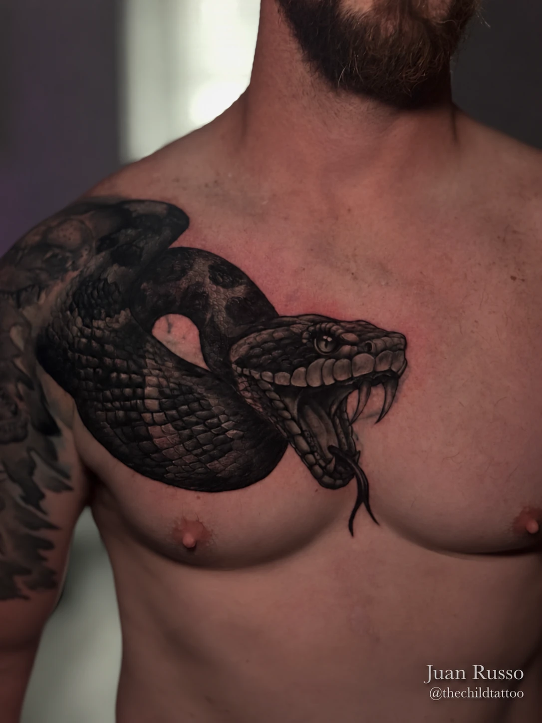 Chest snake tattoo by Juan Russo in Cordova, Memphis.